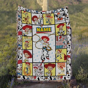 May include: A woven throw blanket featuring a grid pattern with multiple illustrations of the character Jessie from Toy Story. The design includes the text NAME, YEEHAW, and COW GIRL AT HEART, with a cow print border and fringed edges.