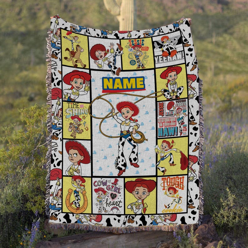 May include: A woven throw blanket featuring a grid pattern with multiple illustrations of the character Jessie from Toy Story. The design includes the text NAME, YEEHAW, and COW GIRL AT HEART, with a cow print border and fringed edges.