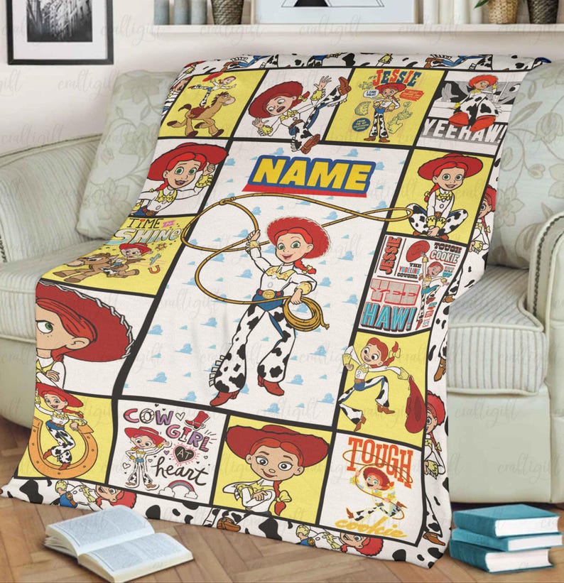 May include: A fleece blanket featuring a grid pattern with multiple illustrations of the character Jessie from Toy Story. The design includes yellow and white panels with text such as NAME, YEEHAW, and TOUGH COOKIE, alongside images of Jessie with a lasso.
