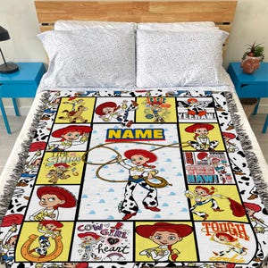 May include: A woven throw blanket featuring a grid of multiple illustrations of the character Jessie from Toy Story, including text such as NAME, YEE HAW, and COW GIRL AT HEART, with a cow print border and fringed edges on all sides.