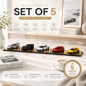 May include: A set of five clear acrylic display cases for model cars, each featuring a black base with a reflective gold-toned surface. The cases are rectangular, transparent, and designed to hold individual miniature vehicles in silver, black, white, red, and yellow.