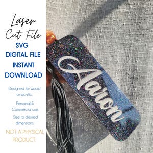 May include: A glittery bookmark with the name "Aaron" in white script. The bookmark is a digital file for wood or acrylic, with text that reads "Laser Cut File," "SVG Digital File," and "Instant Download."