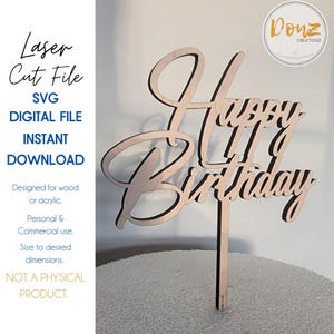May include: A wooden "Happy Birthday" cake topper with a cursive font. The topper is designed for use with a cake or other baked good. The topper is available as a digital download and can be sized to fit any cake.