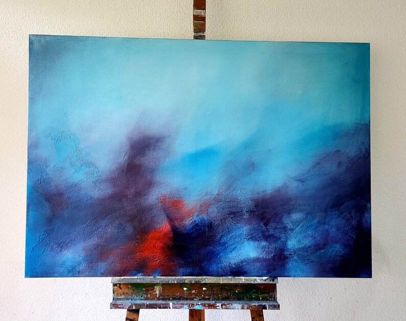 May include: Abstract painting on canvas with a blue, purple, and red color scheme. The painting is on an easel.