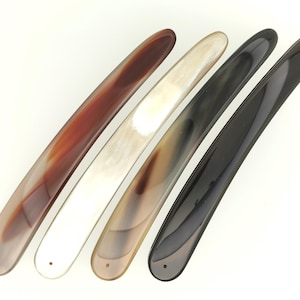 May include: Four straight razors with different colored handles. The handles are made of horn and are brown, white, black, and a mottled brown.