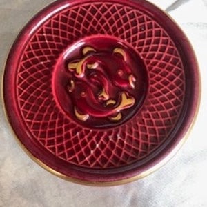 Vallauris garnet red bottle coaster with gold-edged fish