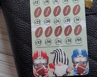 May include: A green and white printable chart with a football theme. The chart has a title that says "Kickoff Savings Challenge" and "Save £420". The chart has 20 football icons with dollar amounts from £2 to £40.