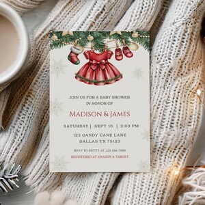 May include: A baby shower invitation with a red dress and baby shoes illustration. The invitation includes the text "Join us for a baby shower in honor of Madison & James" and event details. The invitation is on a cream background with snowflakes.