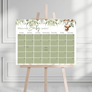 Può includere: Un calendario verde e bianco con un bordo di foglie e una piccola illustrazione di un orso. Il calendario è intitolato "Quando arriverà il bambino?" e comprende i mesi di giugno e luglio.