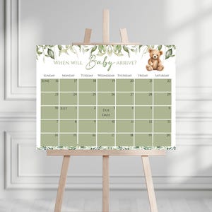 May include: A green and white calendar with the text "WHEN WILL Baby ARRIVE?" and a cartoon bear. The calendar is for June and July and has a space to mark the due date.