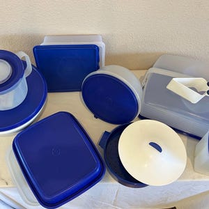 May include: A set of three ceramic mugs with a speckled, matte finish. The mugs are in shades of cream, light gray, and dark gray. Each mug has a simple, minimalist design and a rounded handle.