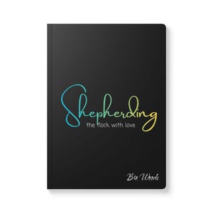 May include: Black notebook with the word "Shepherding" in a teal to yellow gradient script. Below the word is "the flock with love" in a smaller font. The words "Big Words" are at the bottom.