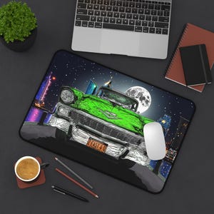 May include: A green vintage car with a license plate that reads "2 EAST 4 U" is driving through a city at night. The car is surrounded by tall buildings and a full moon.
