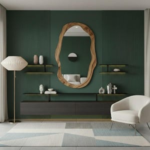 May include: A modern living room with a dark green accent wall, featuring a large, organic-shaped wooden mirror. The room includes a white armchair, a floor lamp, floating shelves, and a low cabinet. A geometric rug adds a touch of color.