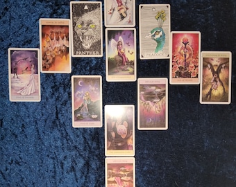 May include: Tarot card spread with ten cards, including the Panther, Peacock, Ace of Wands, Five of Swords, Five of Cups, The Unknown Card, and Four of Swords cards. The cards are on a blue background.