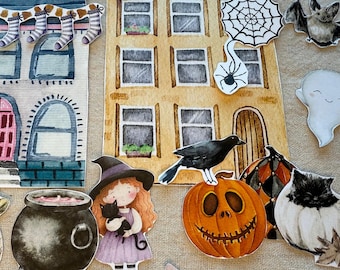 Puede incluir: Ilustraciones en acuarela de recortes con temática de Halloween. Incluye una casa embrujada, bruja, gato negro, calabaza, murciélago, fantasma, rana, araña, caldero y caramelos. Las casas tienen el texto "BOO" y "BOO BOO".