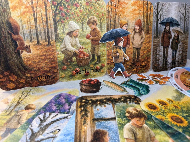 May include: A collection of illustrated seasonal cards featuring children and autumn scenes. The cards depict children picking apples, walking in the rain, and a squirrel on a tree. The word "Autumn", "September", "October", and "November" are visible.