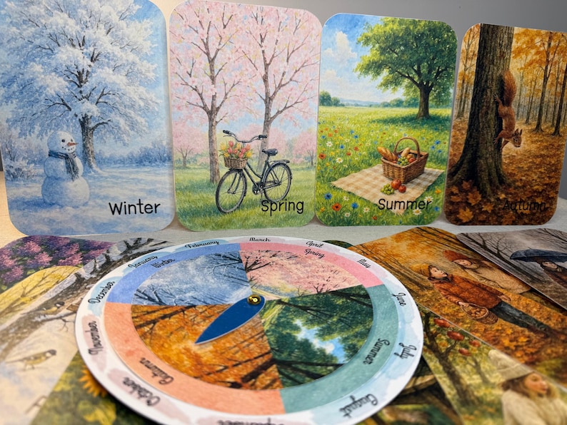 May include: A set of seasonal art cards depicting winter, spring, summer, and autumn scenes. The winter card shows a snowman, spring features a bicycle, summer has a picnic, and autumn shows a squirrel. A circular seasonal calendar is also included.