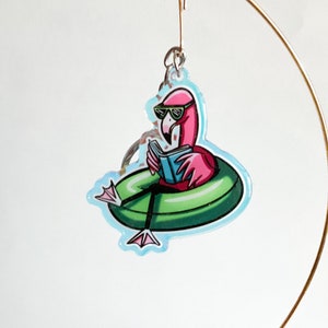 May include: A pink flamingo wearing sunglasses and reading a book while floating on a green inflatable ring. The flamingo and ring are on a clear background.