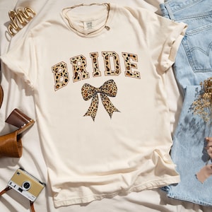 Leopard Print Coquette Comfort Colors Bride Shirt; Animal Print Bow Wedding T-shirt; Fun, Casual Honeymoon or Bachelorette Shirt for Her