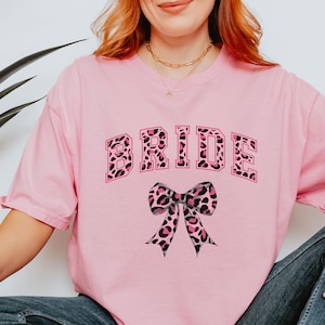 Pink Leopard Print Coquette Comfort Colors Bride Shirt; Animal Print Bow Wedding T-shirt; Fun, Casual Honeymoon/Bachelorette Shirt for Her