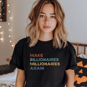 May include: A black t-shirt with the text "MAKE BILLIONAIRES MILLIONAIRES AGAIN" in rainbow colours.