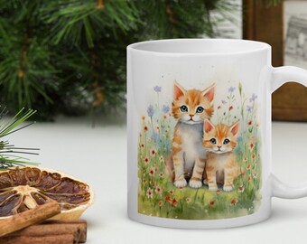 May include: White ceramic mug with a watercolor illustration of two orange tabby kittens sitting in a field of flowers.
