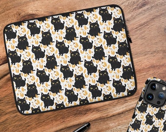 May include: A black and white phone case with a repeating pattern of black cats and gold leaves. The case has the name "Maddie" printed on the back.