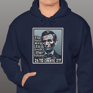 May include: Navy blue hoodie with a white rectangle featuring a portrait of Abraham Lincoln and the quote "The best way to predict the future... is to create it!"