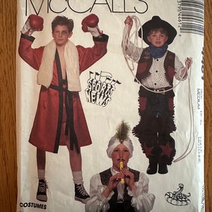 May include: A sewing pattern for children's costumes. The pattern includes three different costumes: a boxer, a cowboy, and a musician. The pattern is from McCall's and has the number 44612. The text on the pattern reads "Tough Stuff... Little Boys Make Believe, Be a Boxer, Combat G.I., Cowboy, Pirate, Sheik, Karate Champ."