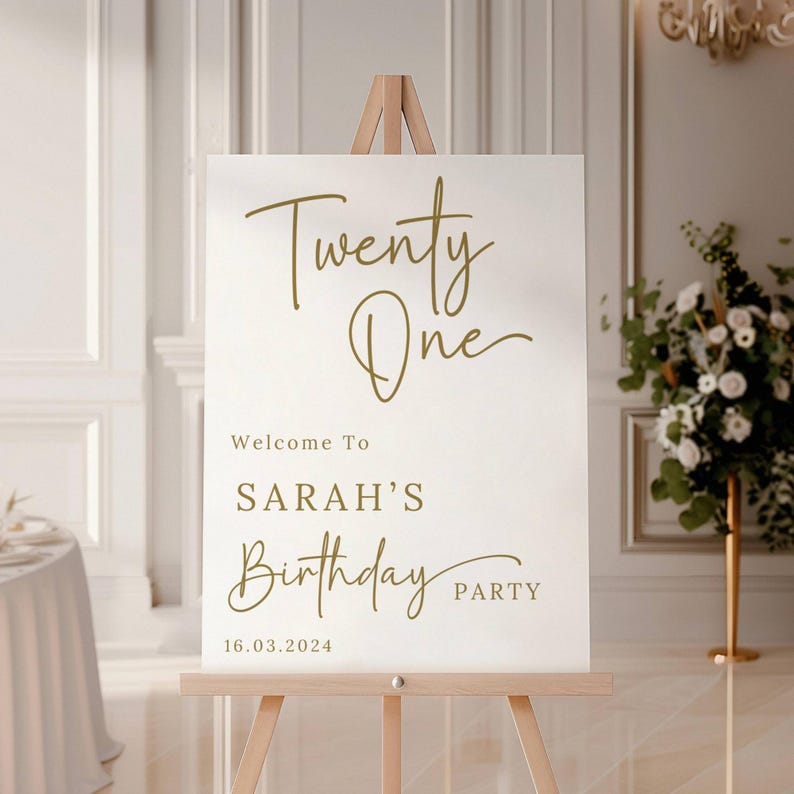 May include: White welcome sign with gold lettering. The sign reads "Twenty One" and "Welcome to Sarah's Birthday Party" with the date "16.03.2024".