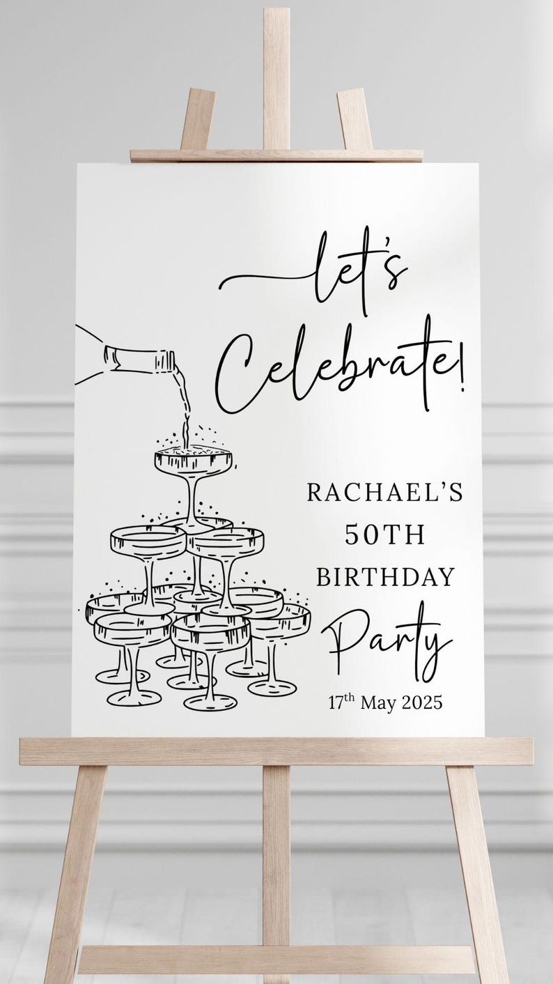 Puede incluir: Un letrero rectangular blanco con un dibujo de l&iacute;neas negras de una torre de copas de champ&aacute;n siendo llenada por una botella. El texto dice: let's celebrate! RACHAEL'S 50TH BIRTHDAY Party 17th May 2025. El letrero est&aacute; sobre un caballete de madera.