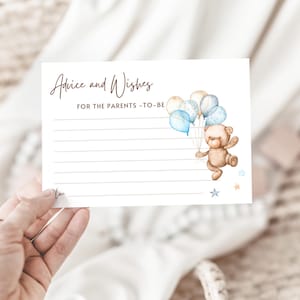 May include: Advice and Wishes for the parents-to-be card with a brown teddy bear holding blue and white balloons. The card has lined space for writing.