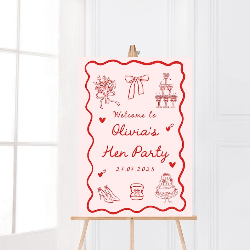 May include: A pink sign on a wooden easel, featuring red line art illustrations. The sign reads "Welcome to Olivia's Hen Party" with drawings of a bouquet, bow, champagne glasses, hearts, shoes, a ring, and a cake. The date 27.07.2025 is also shown.