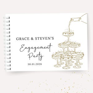 K&ouml;nnte beinhalten: Wei&szlig;es Spiralnotizbuch mit goldenem Text und Illustrationen. Auf dem Cover steht "GRACE & STEVEN'S Engagement Party 30.01.2026" mit einer Champagnerturm-Illustration. Goldene Konfetti-Punkte zieren den Hintergrund.