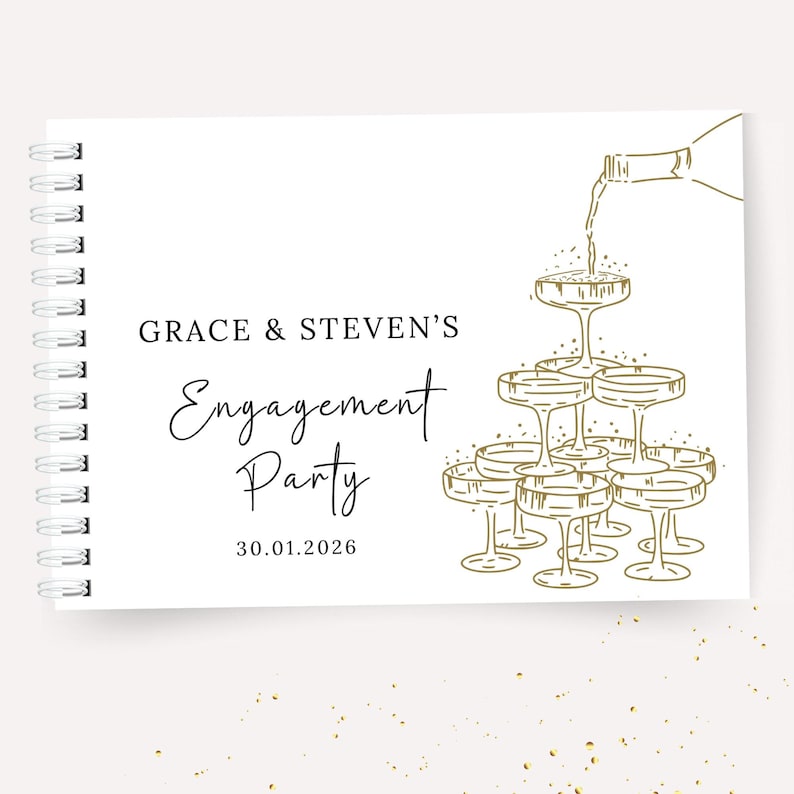 K&ouml;nnte beinhalten: Wei&szlig;es Spiralnotizbuch mit goldenem Text und Illustrationen. Auf dem Cover steht "GRACE & STEVEN'S Engagement Party 30.01.2026" mit einer Champagnerturm-Illustration. Goldene Konfetti-Punkte zieren den Hintergrund.