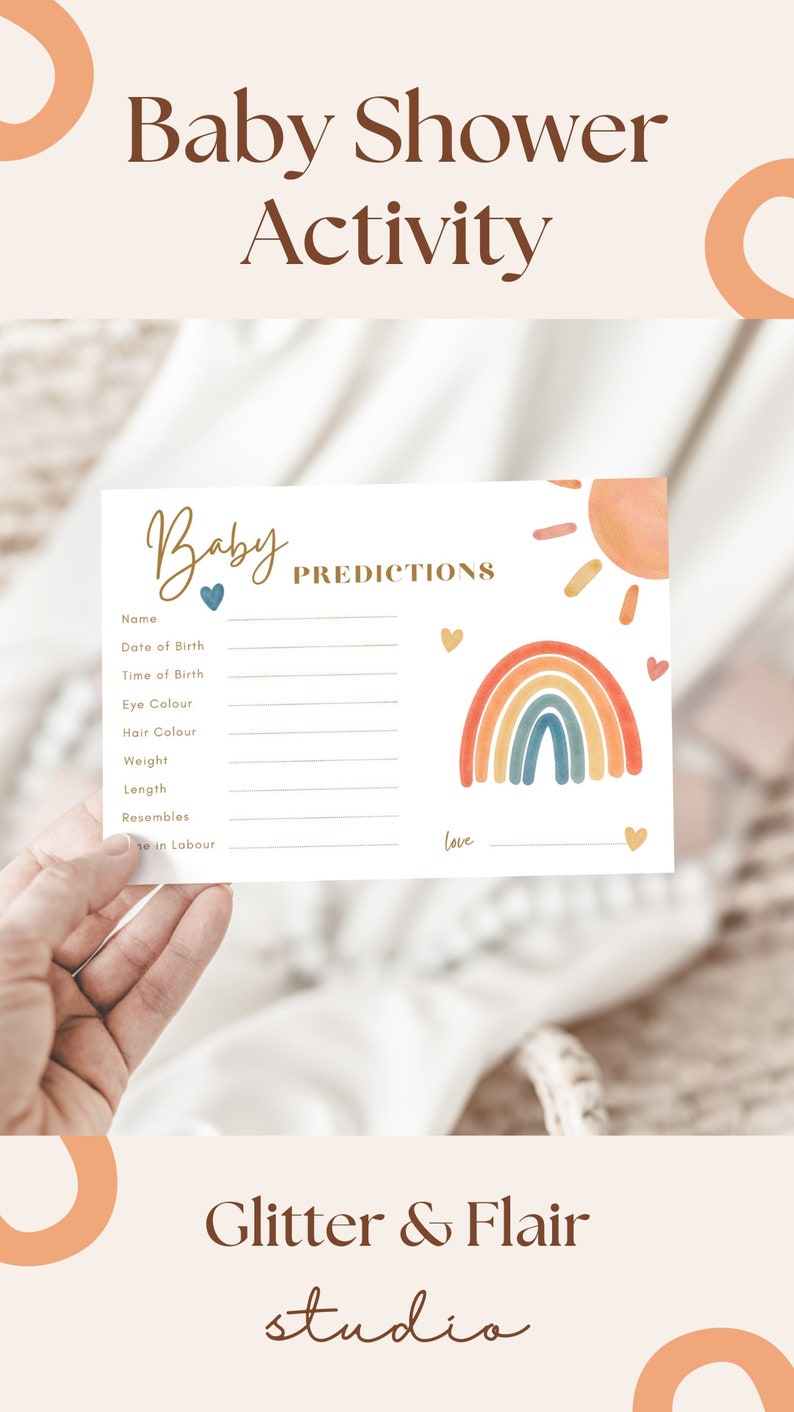 May include: A baby shower activity card with the words "Baby Shower Activity" at the top. The card features a rainbow and sun graphic, with spaces for predictions like name, date of birth, and weight. The card is held by a hand.