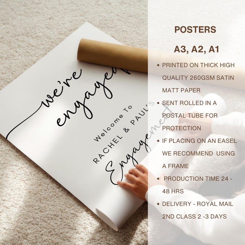 May include: A white rectangular poster featuring black text that reads "we're engaged" in a cursive script, followed by "Welcome To" and "RACHEL & PAUL'S Engagement" in a mix of block and script fonts. The poster is shown partially rolled.