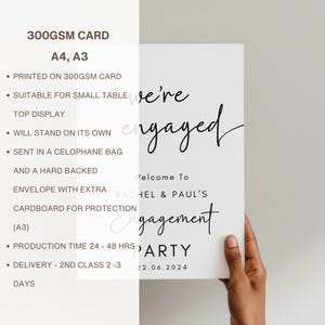 May include: A white rectangular sign printed on 300gsm card stock featuring the black text We're engaged, Welcome To, RACHEL & PAUL'S, Engagement PARTY, and the date 22.06.2024. The sign is available in A4 and A3 sizes for tabletop display.