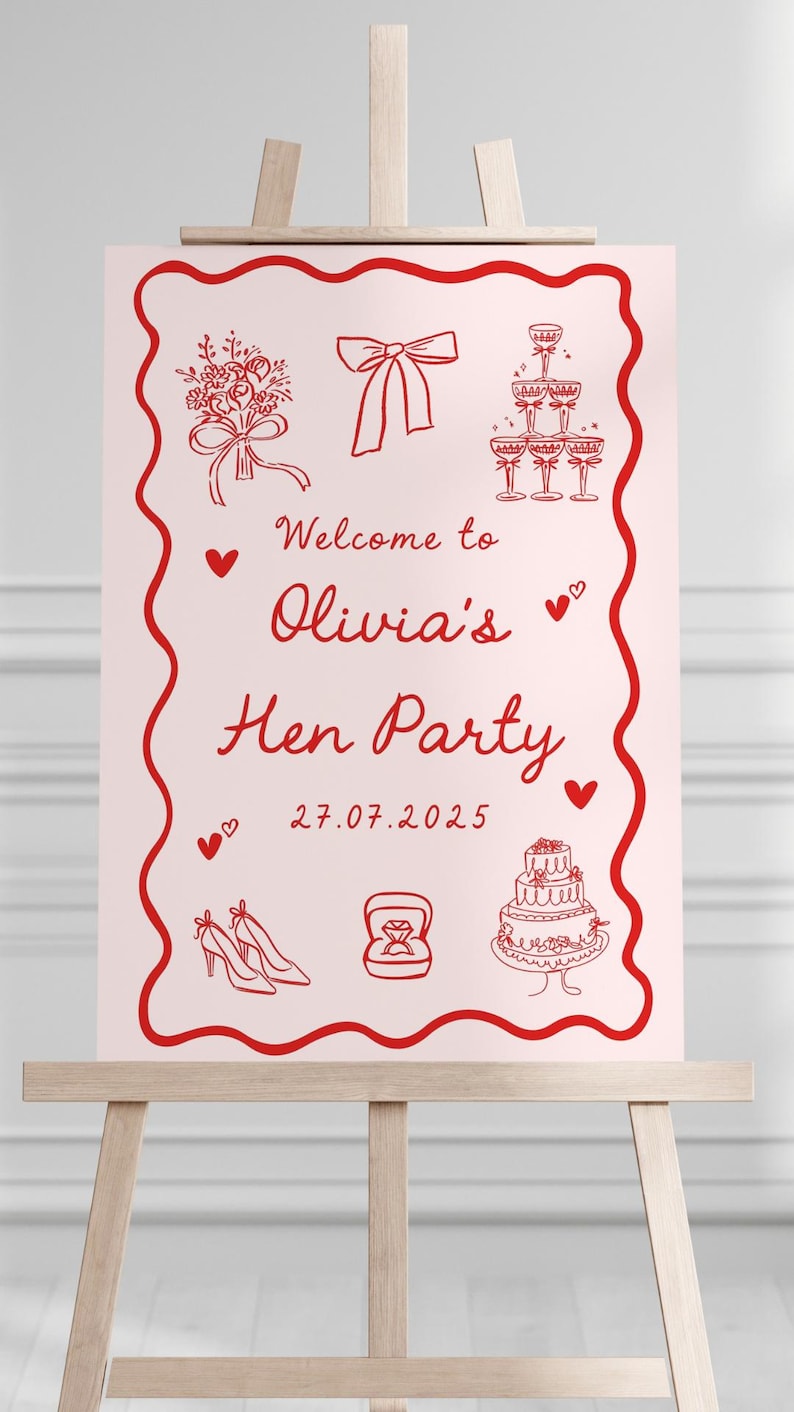 May include: A pink sign on a wooden easel with red illustrations and text. The sign reads "Welcome to Olivia's Hen Party" with drawings of a bouquet, bow, champagne flutes, shoes, a ring, and a cake. The date 27.07.2025 is shown.