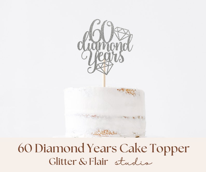 Silver cake topper with cursive writing saying '60 diamond years', with diamonds, pictured on a cake