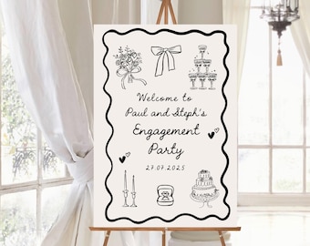 May include: An engagement party sign on a wooden easel. The sign has a black wavy border and features illustrations of a bouquet, bow, champagne flutes, hearts, candles, a ring, and a cake. Text reads "Welcome to Paul and Steph's Engagement Party 27.07.2025."