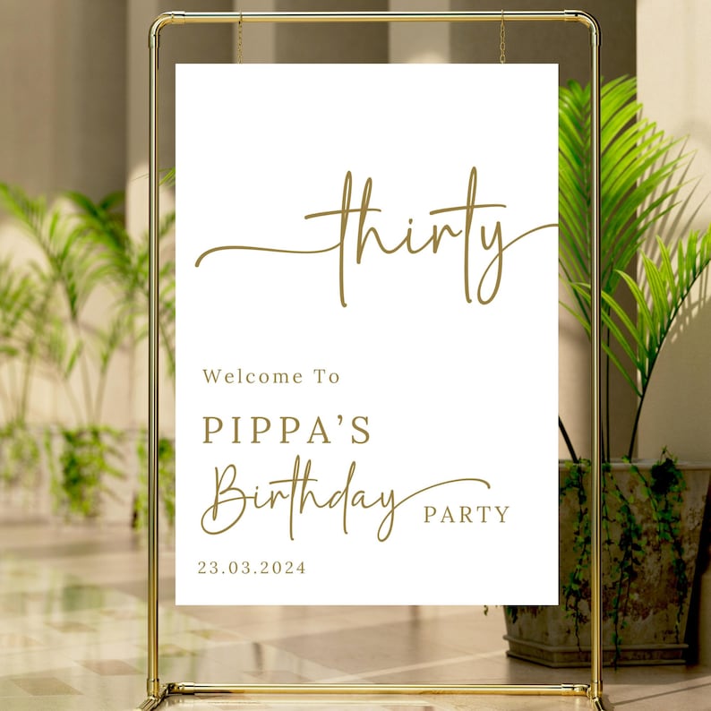 May include: A gold metal frame holds a white sign with gold text. The sign reads "thirty" in cursive, followed by "Welcome To PIPPA'S Birthday PARTY 23.03.2024". The sign is for a birthday celebration.