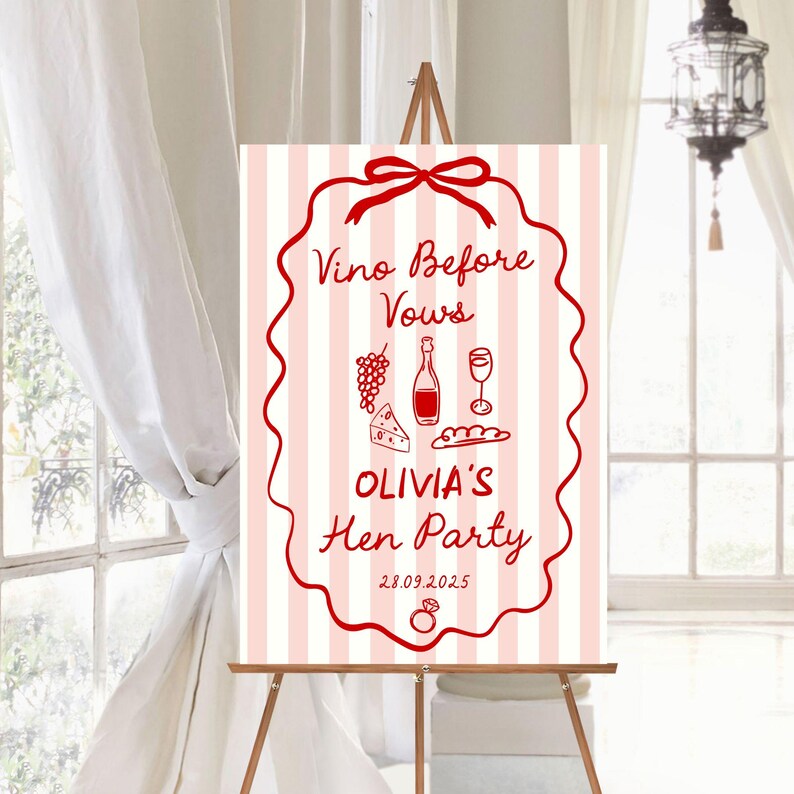 May include: A sign on an easel with a pink and white striped background. The sign has a red border and text that reads "Vino Before Vows" and "Olivia's Hen Party" with illustrations of wine, grapes, cheese, and bread. The date 28.09.2025 is also included.