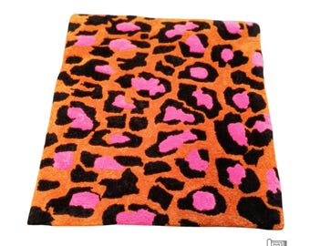 Leopard pattern carpet a soft, thick carpet with a leopard pattern in orange and pink colors jungle colorfull animal pattern