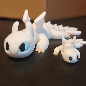 Artikulerande babyljus / Fidget sensorisk leksak / Hur man tränar sin drake bild 1