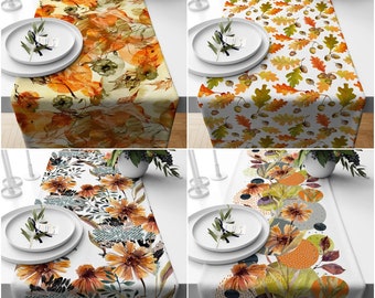 May include: Four different table runners with autumnal designs. The runners feature various patterns of leaves, acorns, and geometric shapes in shades of orange, brown, yellow, and gray.