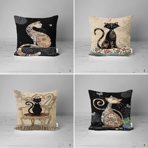May include: Four decorative throw pillows featuring black cats with different designs. The pillows are all square and have a white background. The first pillow features a black cat sitting on a patterned cushion. The second pillow features a black cat sitting on a floral cushion. The third pillow features a black cat sitting on a chair. The fourth pillow features a black cat sitting on a floral cushion.