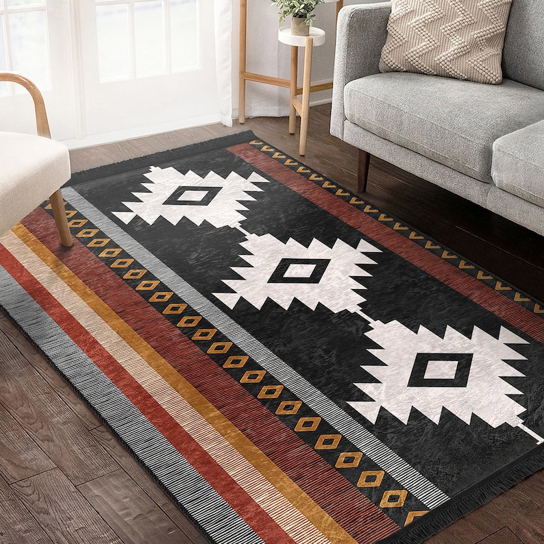 May include: A black and white geometric rug with a southwestern design. The rug has a fringed border and features a pattern of diamonds and triangles. The rug is on a wooden floor.