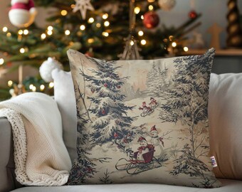 May include: Square cushion featuring a winter scene with snow-covered trees and snowmen sledding. The cushion has a vintage aesthetic with a cream background and a detailed illustration in shades of grey, red, and brown. The cushion is placed on a grey sofa.